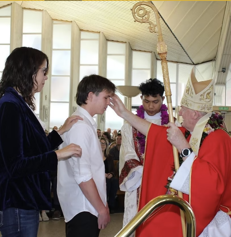 Bishop confirming a candidate in the parish