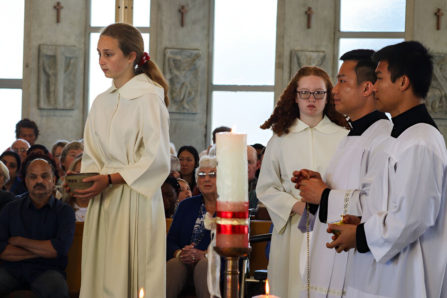 Young parishioners in procession with the Paschal candle at St Joseph's